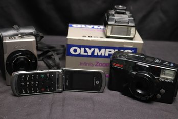 Lot Features An Olympus Camera And Infinity Zoom Lens 210, And More