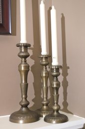 Lot Of 3 Brass Candlesticks In Assorted Sizes With Tapers.