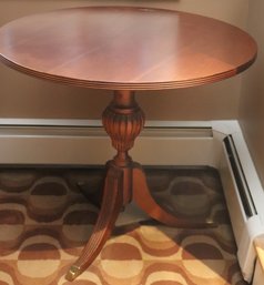 Duncan Phyfe Style Round Wood Table Having 3 Legs With Brass Mounts.