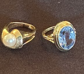 Two 14K YG RINGS: 14K YG PEARL RING SIZE 5.25 AND 14K YG BLUE TOPAZ RING SIZE 5.75 APPROX WEIGNT 6.8 DWT