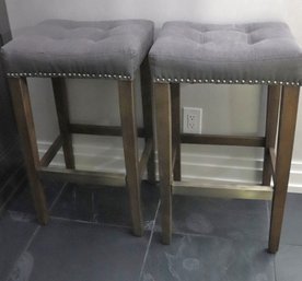 Pair Of Contemporary Bar Stools With Light Wood Legs And Nail Head Trim