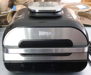 A Ninja Air Fryer In Black And Chrome Finish