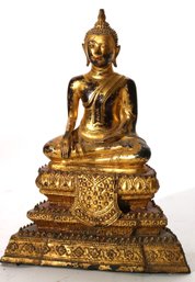 Gilt Metal Thai Style Buddha With Gold Highlights On Embossed Plinth