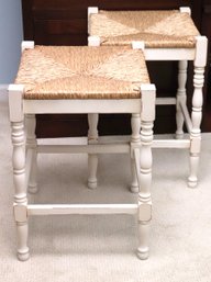 Two White Wood Stools With Raffia Seats.