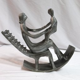 A Vintage Metal Sculpture Of Mother And Child In A Rocking Chair- In The Style Of Henry Moore.