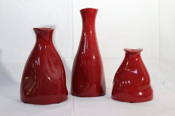 Trip Of Maroon Pottery Vases With Minimalist Designs.