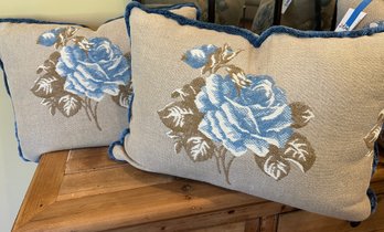 Two Custom Made Down Filled Pillows Upholstered In Heavy Tan Linen With Large Blue Rose And Blue Fringes.