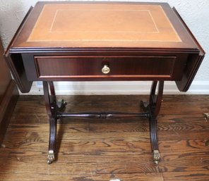 Diminutive Mahogany Leather Top Side Table With Drop Leaf Sides, And Brass Paw Feet.