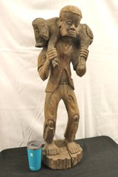 Tall Vintage Carved Wood Figure Of Haitian Man Carrying A Pig.
