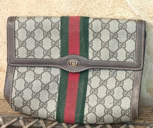 A Pre-owned Gucci Clutch With Iconic Design And Red, Green Stripe.