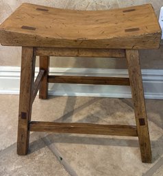 An Asian Style Hand Crafted Wooden Stool With Slightly Curved Seat.