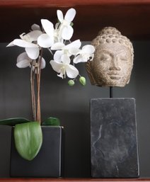 Composition Buddha Head On Marble Base And Faux Orchid, In Black Ceramic Planter.