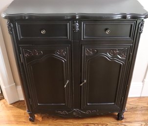 Narrow Black Painted 2 Door Cabinet With Carved Details On The Doors.