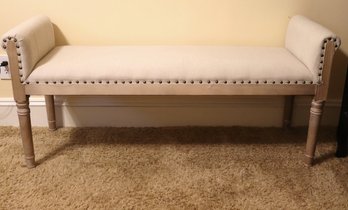 Linen Upholstered Bench With Light Wood Frame And Nail Head Accents.