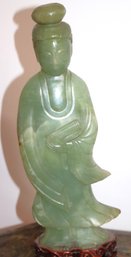 Green Jade Stone Carved Statue Of Guanyin With Flowing Robes & Serene Expression On Carved Wood Base