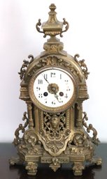 Antique Style Brass Clock With Beautiful Filigree Work With Portrait On Front & White Enamel Face
