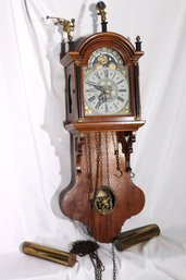 Wooden Case Wall, Clock With Sun And Moon Face And, Atlas And Angels Metal Figures.