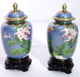 Two Smaller Blue Cloisonne Jars With Lids On Black Wooden Stands.