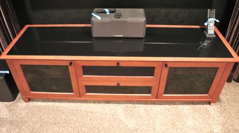 Large Media Console In Medium Toned Wood Framed Black Glass.