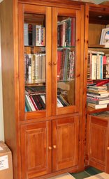 Light Wood Bookcase Cabinet With Glass Front Doors And Glass Shelves As Well As Interior Light