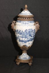 Castilian Bronze Mounted Blue And White Porcelain Urn, With Painted Asian Scenery, And Deity With Rams Head