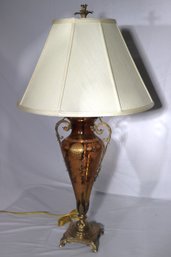 Tall, Elegant Glass, Urn Shaped Lamp With Brass Handles And Sculpted Brass Base.
