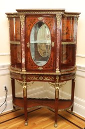 French Marquetry Inlaid Display Cabinet, With Richly Veined Marble, Ormolu, And Mirrored Interior.