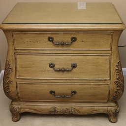 Pair Of Light Wood, Bombe Nightstands With Three Drawers And Protective Glass Top.