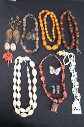 Lot Of Chunky Costume Jewelry Featuring Multiple Stone And Metallic Necklaces, And Amber Look Pieces.