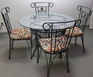 In The Manner Of Versace Wrought Iron Table With Glass Top And 4 Chairs, With Sunburst Accents.