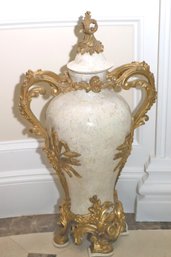 Tall, Elegant French Urn With Bronze Mounts On A Light Beige Background Of Faux Marble.