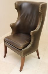 Custom Leather Wing Back Chair With Patinated Nail Head Accents Along The Edges