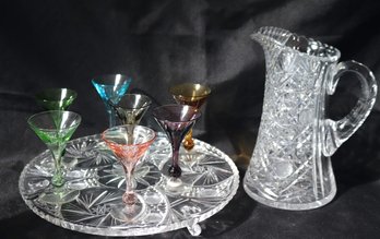 Cut Crystal Pitcher And Footed Tray With 7 Colored Liquor Glasses.