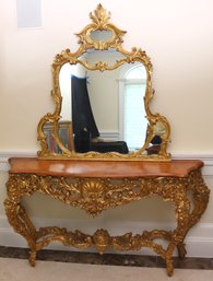 Antique Louis XV Style Wood Top Console With Elaborate Gilt Legs With A Fancy Curved Mirror.