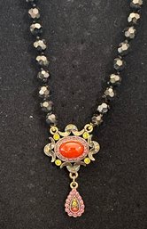 Heidi Daus 16-20 Inch Black Faceted Beaded Necklae With 2 Section Pendnat Having Carnelian Centerstone