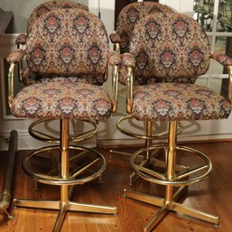 4 Swivel Chromcraft Barstools With A Brass Finish And Custom Tapestry Style Fabric And Foot Rings For Comfort.