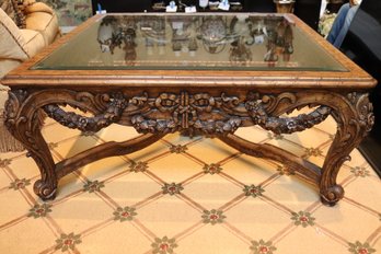 Carved Wood Coffee Table With A Beveled Edge Glass Insert