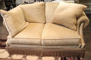 Cozy And Comfortable Henredon Loveseat In A Light Golden Tone With Large Nail Head Accents And Skirted Tassel