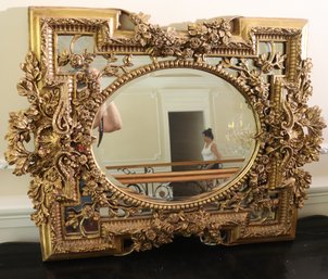 Fancy French Gilt Wood Mirror With Oval Center.