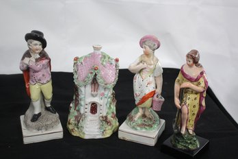 A Lot Of 4 Staffordshire With House, 2 Female Figures And Young Boy With A Cloak