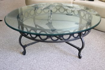 Round Coffee/ Cocktail Table With A Thick Glass Top On A Heavy Wrought Iron Base