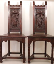 Pair Of Renaissance Style Oak Wood Hall Chairs With Carved Knight Figure Accents On The Back Rest