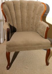 Cozy Armchair With A Tufted Clam Shell Style Backrest And Custom Linen Fabric