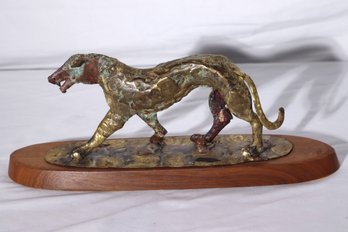 Vintage Hammered Brass Dog Sculpture With A Patinated Finish On A Wood Stand