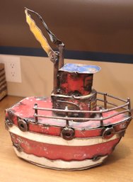 A Decoratively Painted Metal Tugboat With Rustic Appearance.