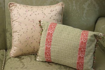 Two Accent Pillows With Textured Fabric, And Delicate Florals.
