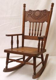 Antique Childs Rocker With Carved Back And Cane Seat