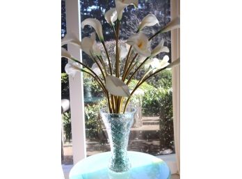 A Tall Cut Glass Vase With Decorative White Lily Silk Flowers.