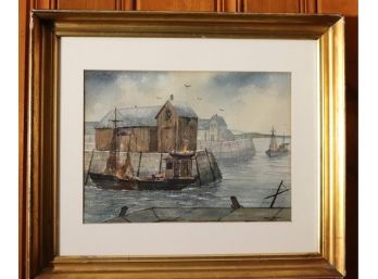 Signed Watercolor Painting Of Boathouse And Harbor In A Gilt Wood Frame.