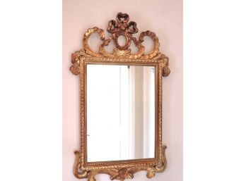 An Italian Baroque Style Gold Framed Mirror With Elaborate Bow Dcor.